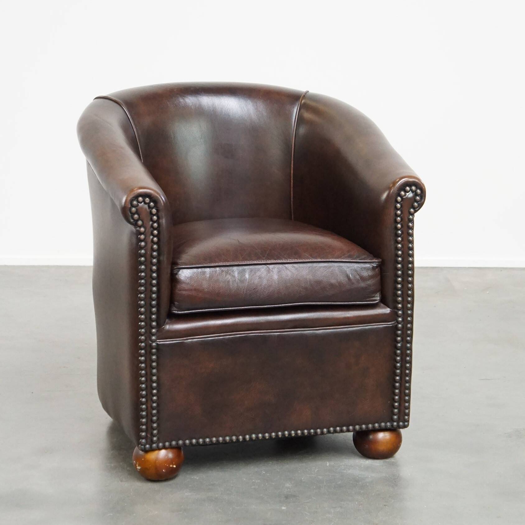luxury dark leather club chair with English-style ball feet
