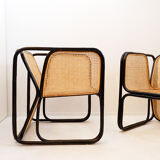 Pair of designer armchairs in curved wood and wicker