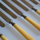 11 antique 19th-century table knives with ivory-colored monogram handles