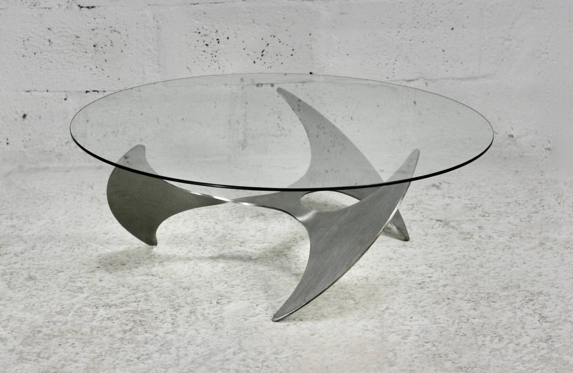 "space age" coffee table. Steel legs, glass slab. Circa 1970