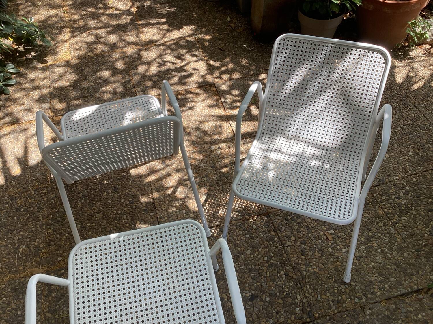 Perforated metal armchairs