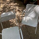 Perforated metal armchairs