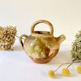 Small Provençal goat jug in creamy white and green enamelled stoneware