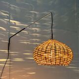 Mid-century modern Danish extendable cantilever wall lamp with a rattan shade, 1960s.