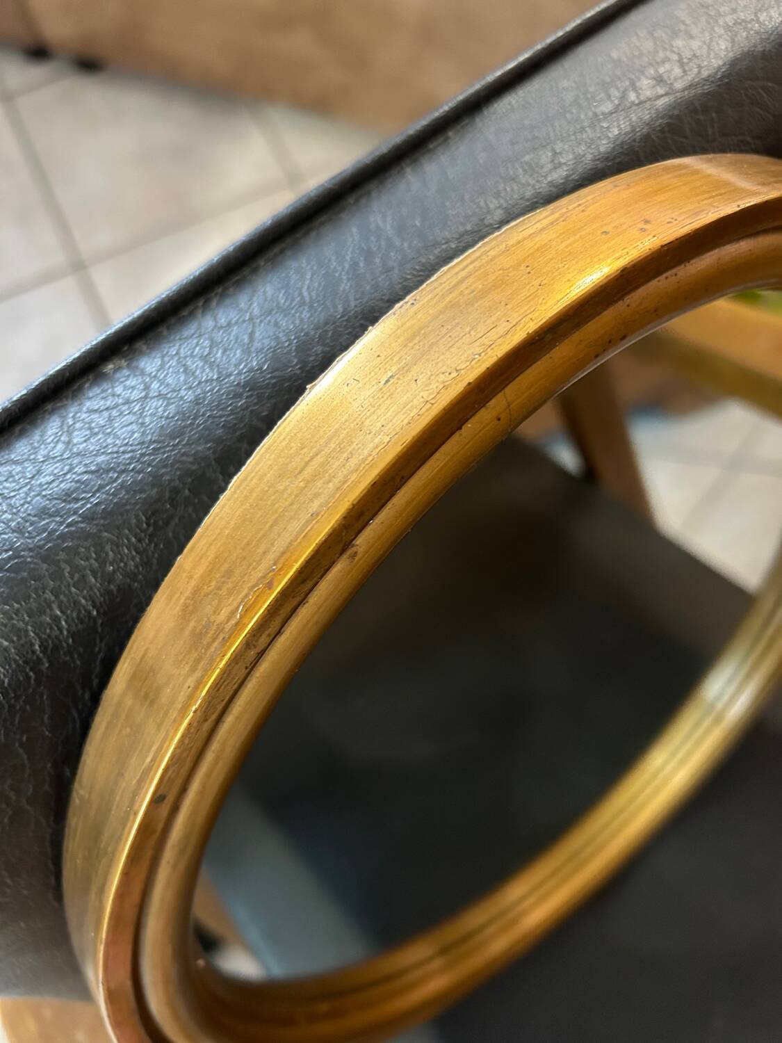 Old oval mirror in gilded wood from the 20th century