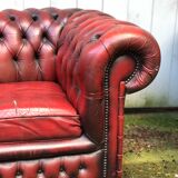 Pair of red leather chesterfield chairs