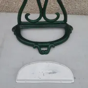 Bottle green enamelled cast iron umbrella stand with a swirl design.