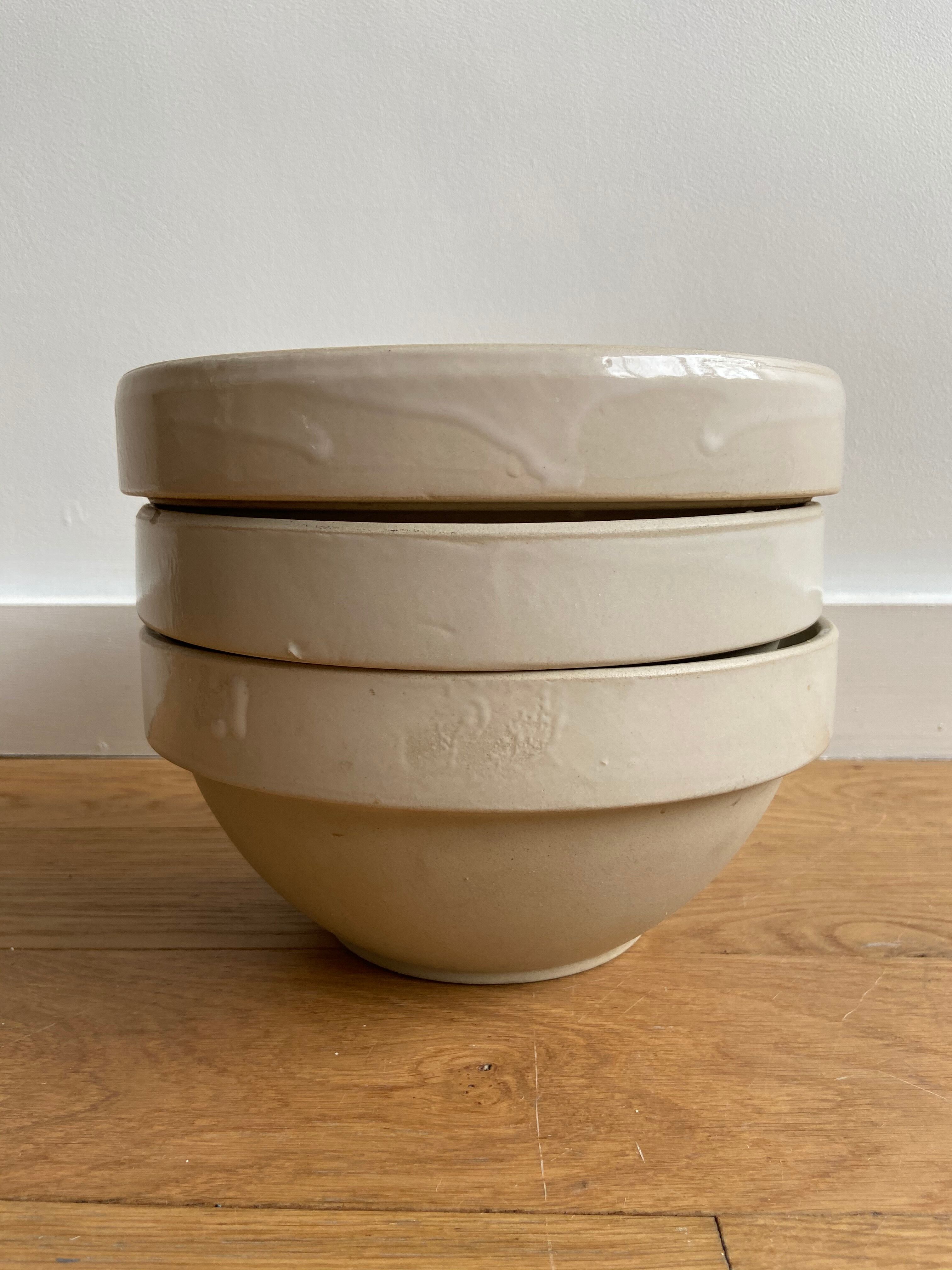 Trio of beige enamelled sandstone bowls