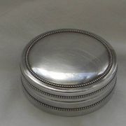 Small round silver metal box SNPA.