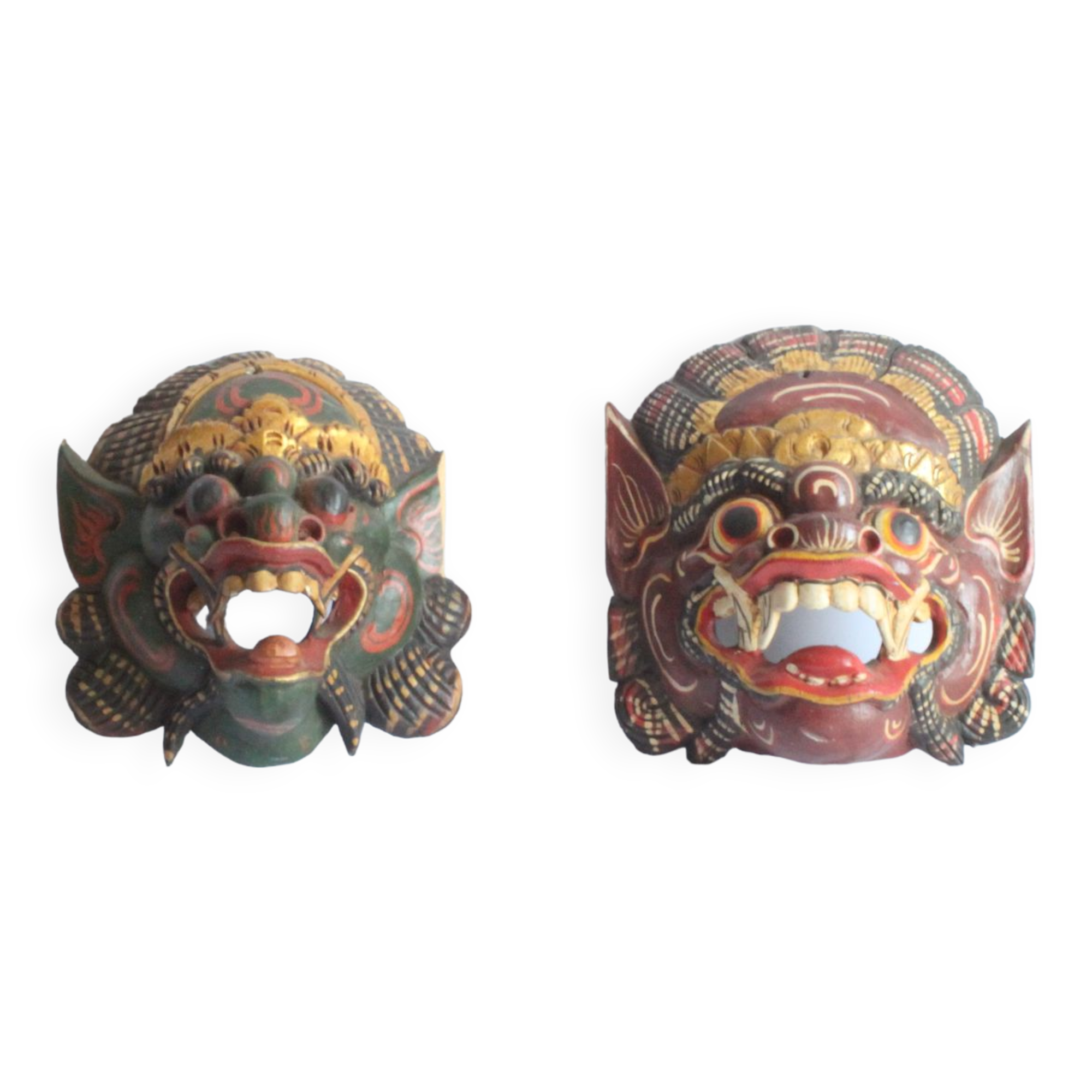 Two polychrome painted and gold leaf gilded Barong dance masks from Bali, Indonesia.