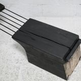 Brutalist chair, black-stained raw wood, steel. Work from the 1970s
