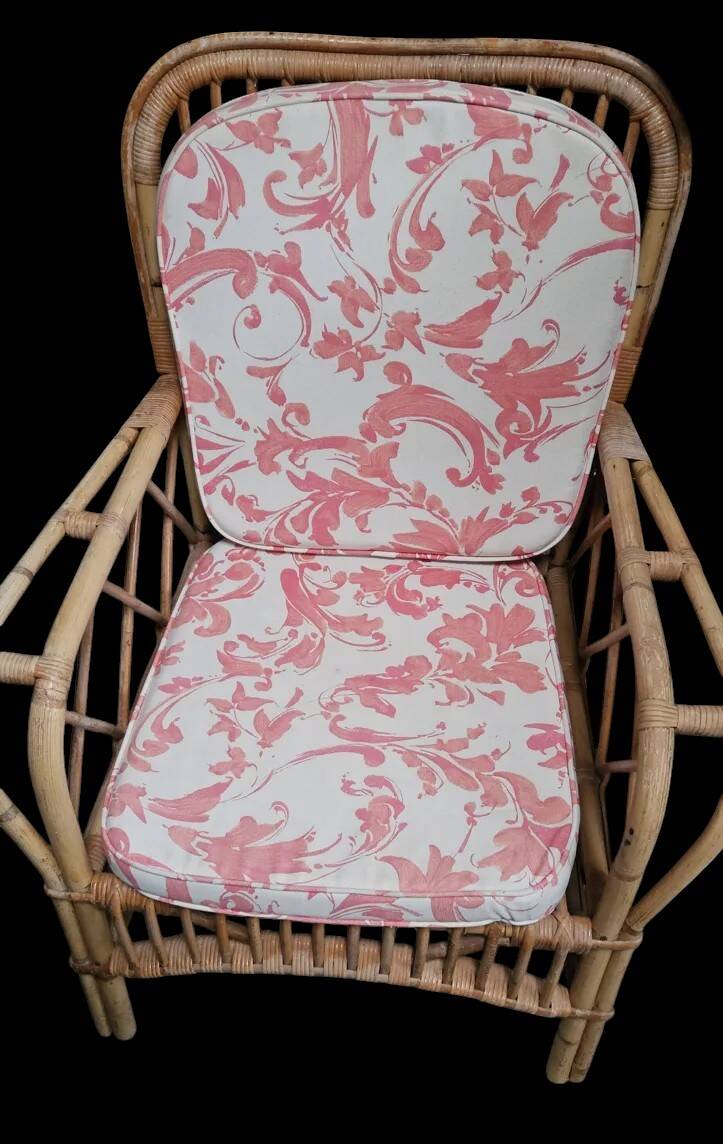 Vintage rattan garden furniture with cushions.