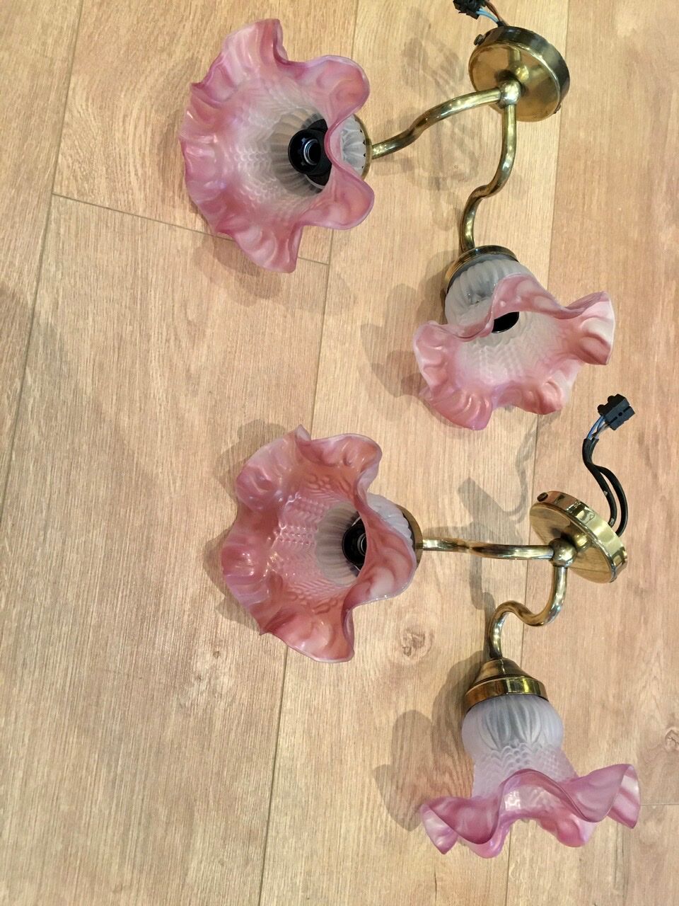 Pair of brass sconces and pink glass