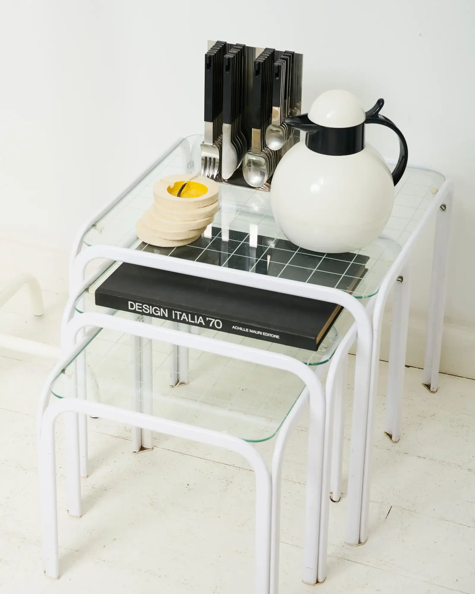 Nested tables in white lacquered metal, Italy, 1970s.