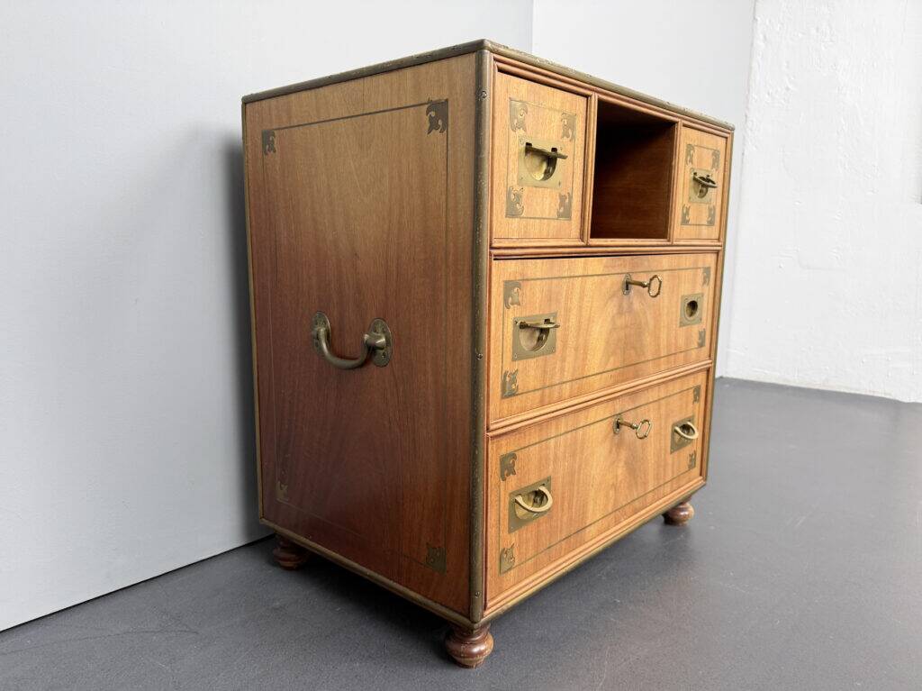 Antique campaign chest / ship’s chest, England, 1940s. Mahogany with a distinctive grain, brass inlays and hardware.