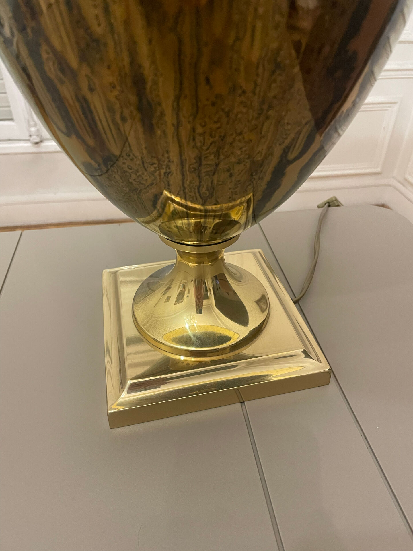 Bronze table lamp with a golden shade.