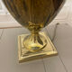 Bronze table lamp with a golden shade.