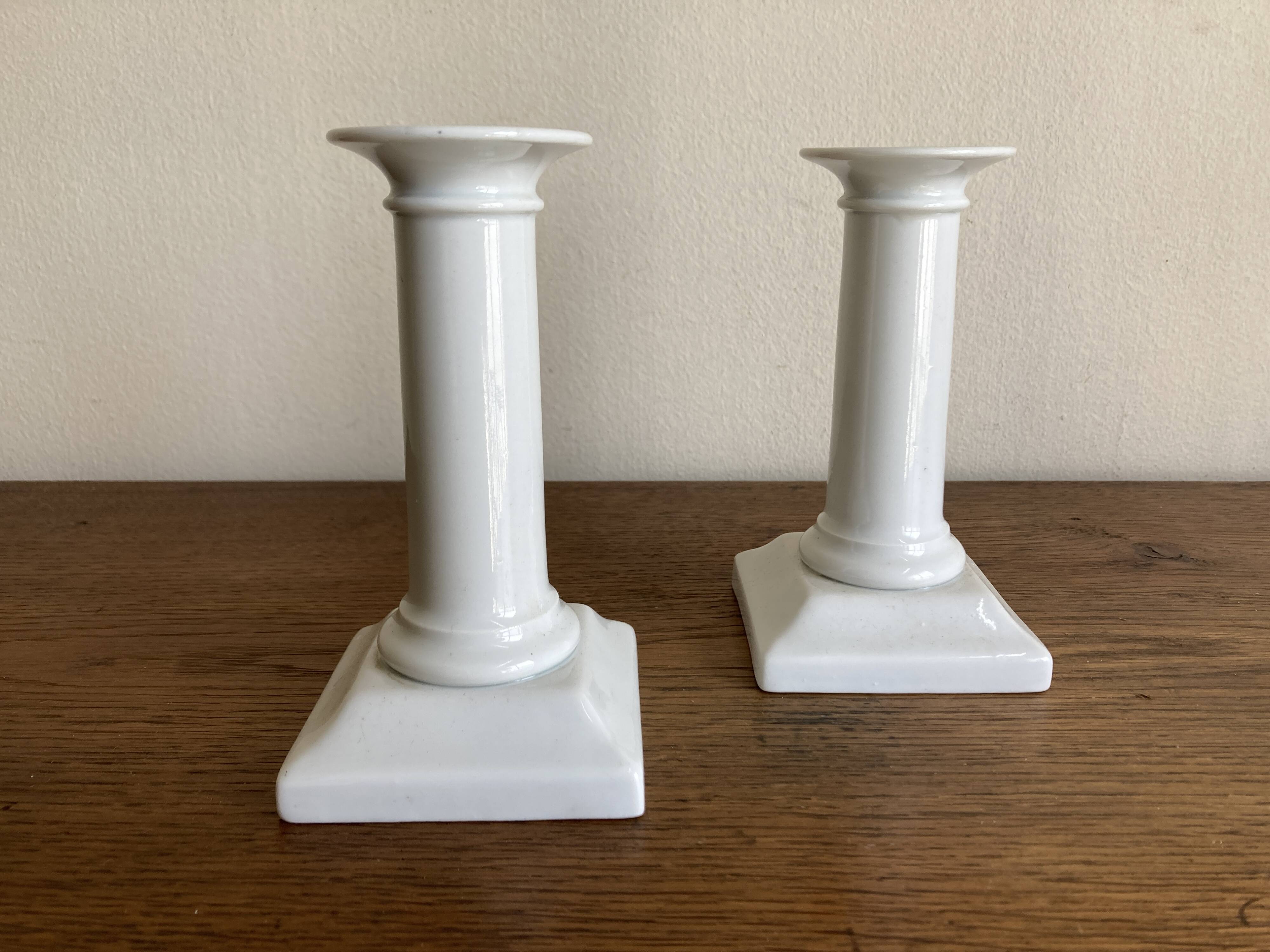 Pair of neo-classical Empire candlesticks from the late 19th century in white porcelain.