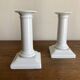 Pair of neo-classical Empire candlesticks from the late 19th century in white porcelain.