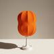 Lamp with a plastic base and a coloured fabric shade in Mid Century style.