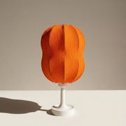 Lamp with a plastic base and a coloured fabric shade in Mid Century style.