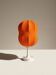 Lamp with a plastic base and a coloured fabric shade in Mid Century style.