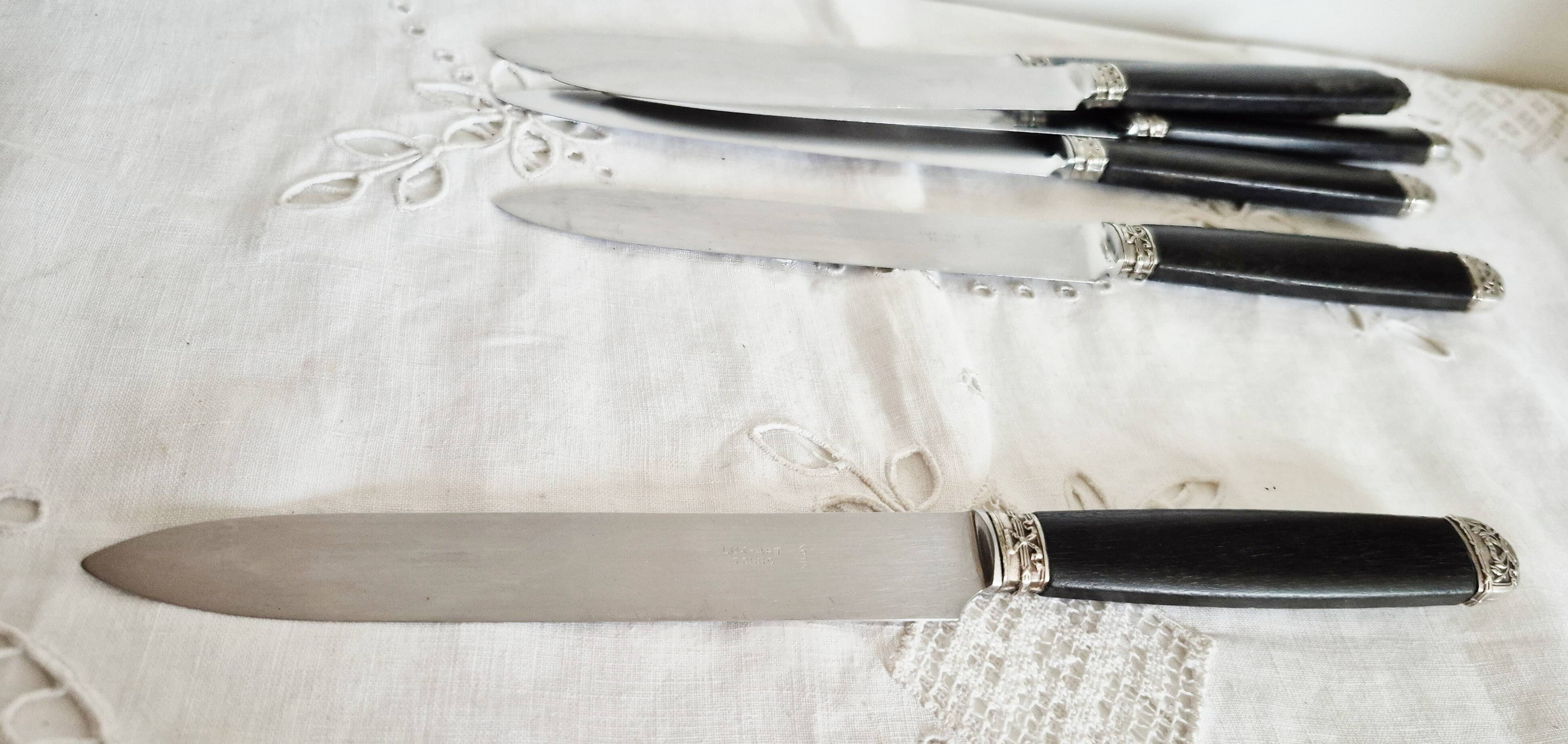 Silver and ebony table knives, stainless steel blade, late 19th century.