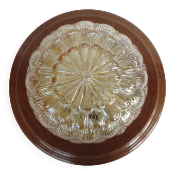ceiling light with amber glass globe, on a round light wood base