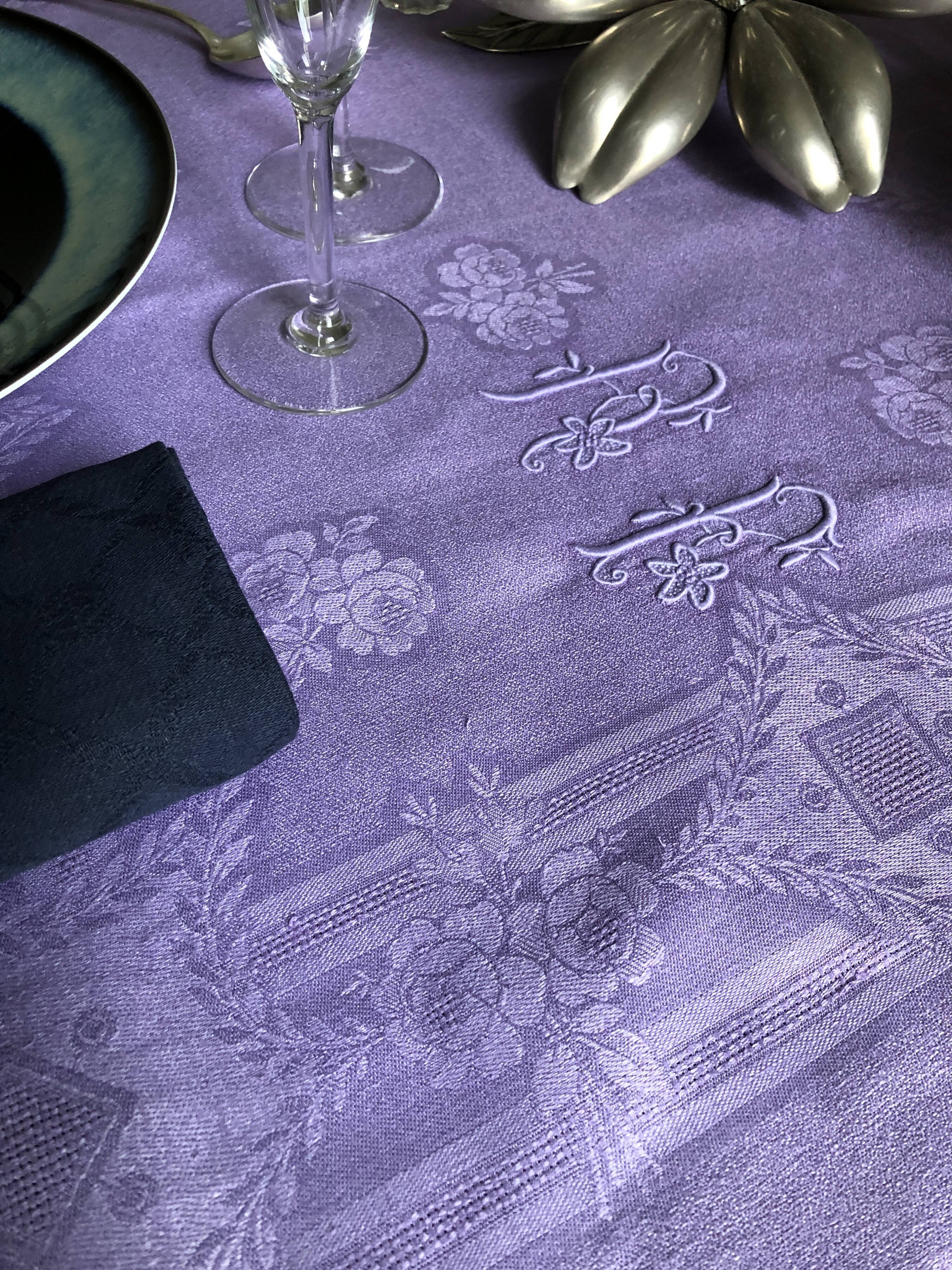 Old damask tablecloth in linen and purple silk