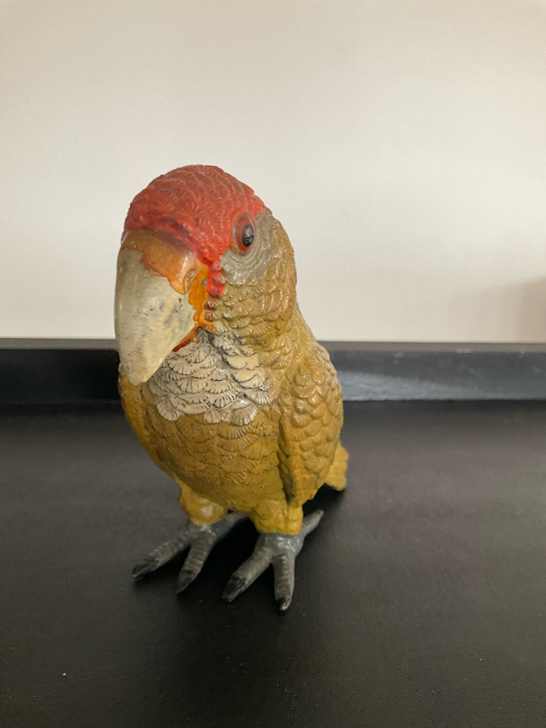Vintage enamelled metal parakeet paperpress
