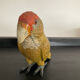 Vintage enamelled metal parakeet paperpress
