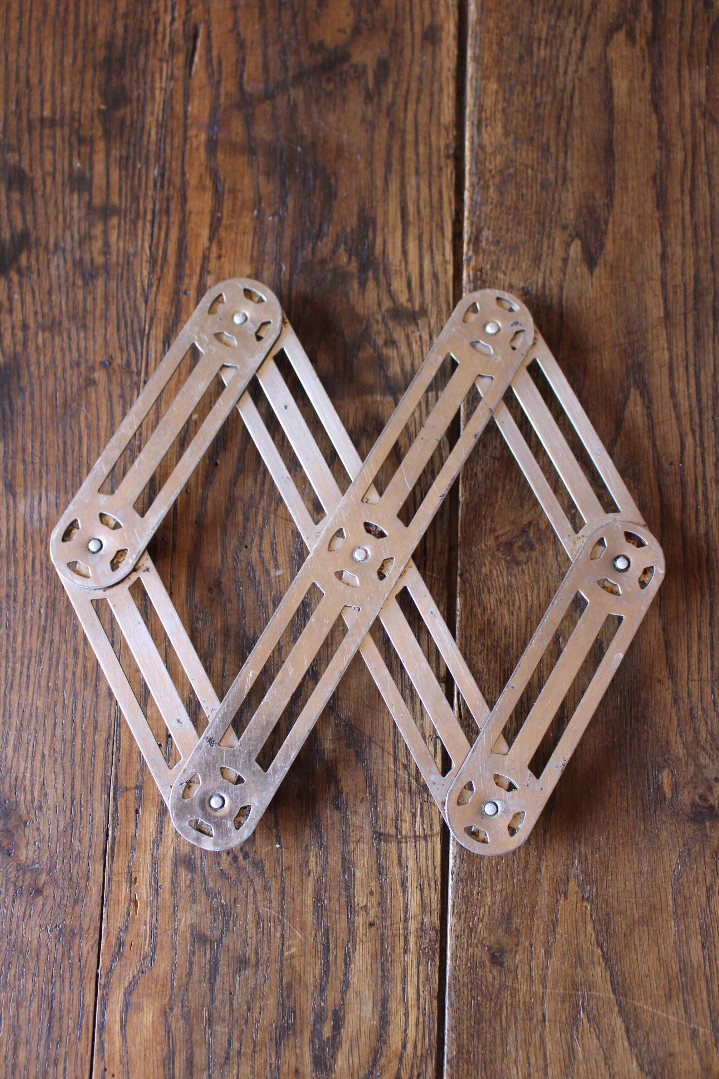 Vintage accordion folding metal trivet