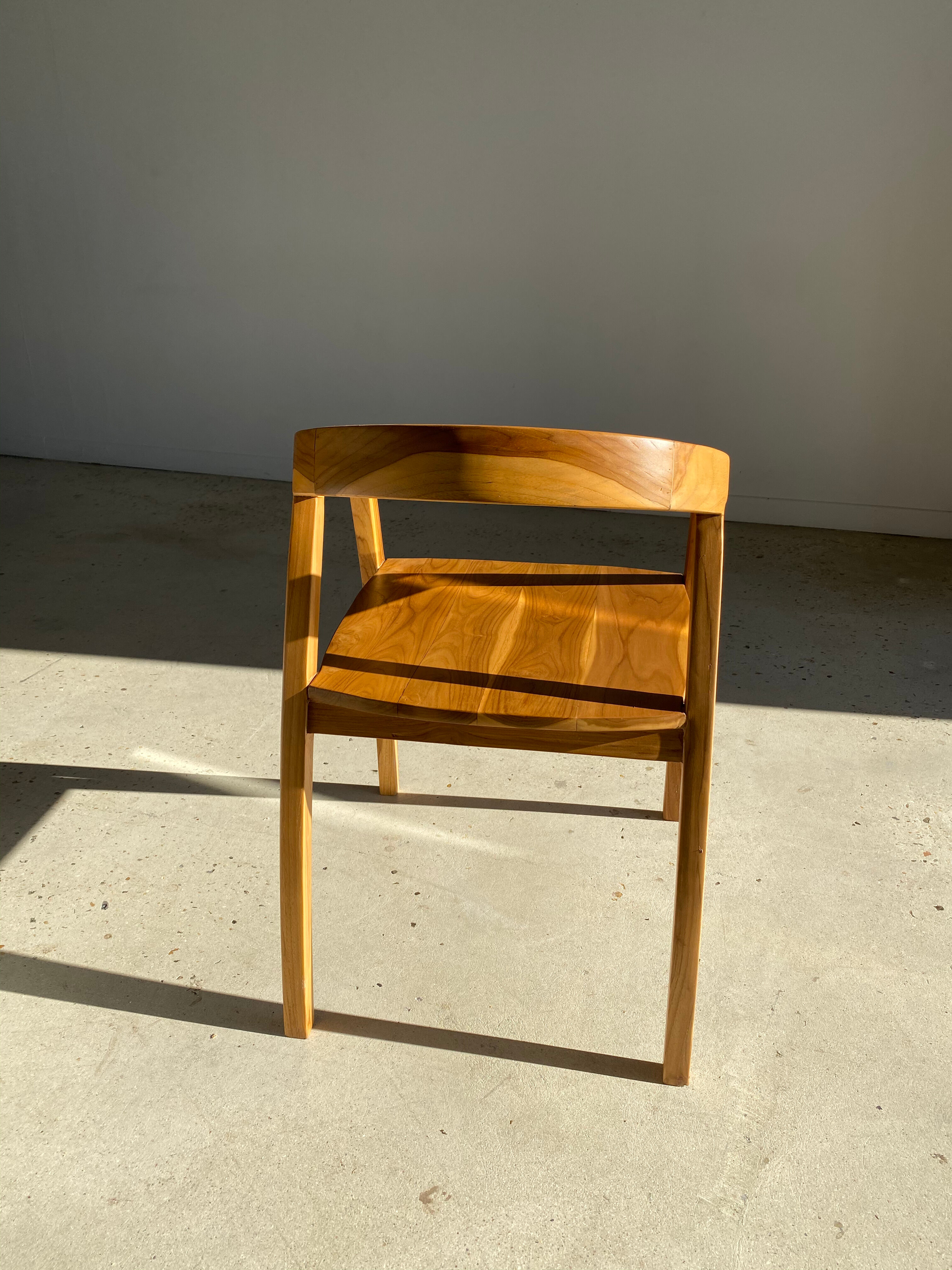 Natural wood chair with wraparound back