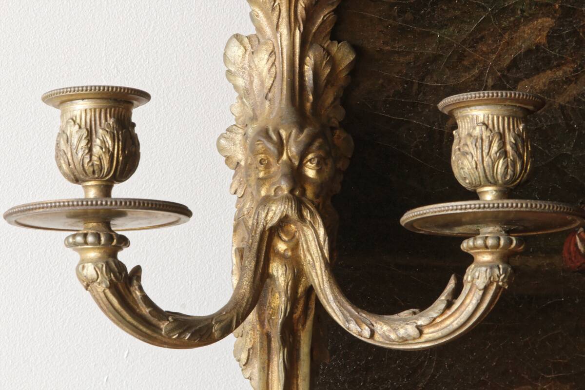 Monobloc gilded bronze wall light, grotesque satyr, two lights.