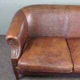 2-seater sofa in sheepskin decorative nails