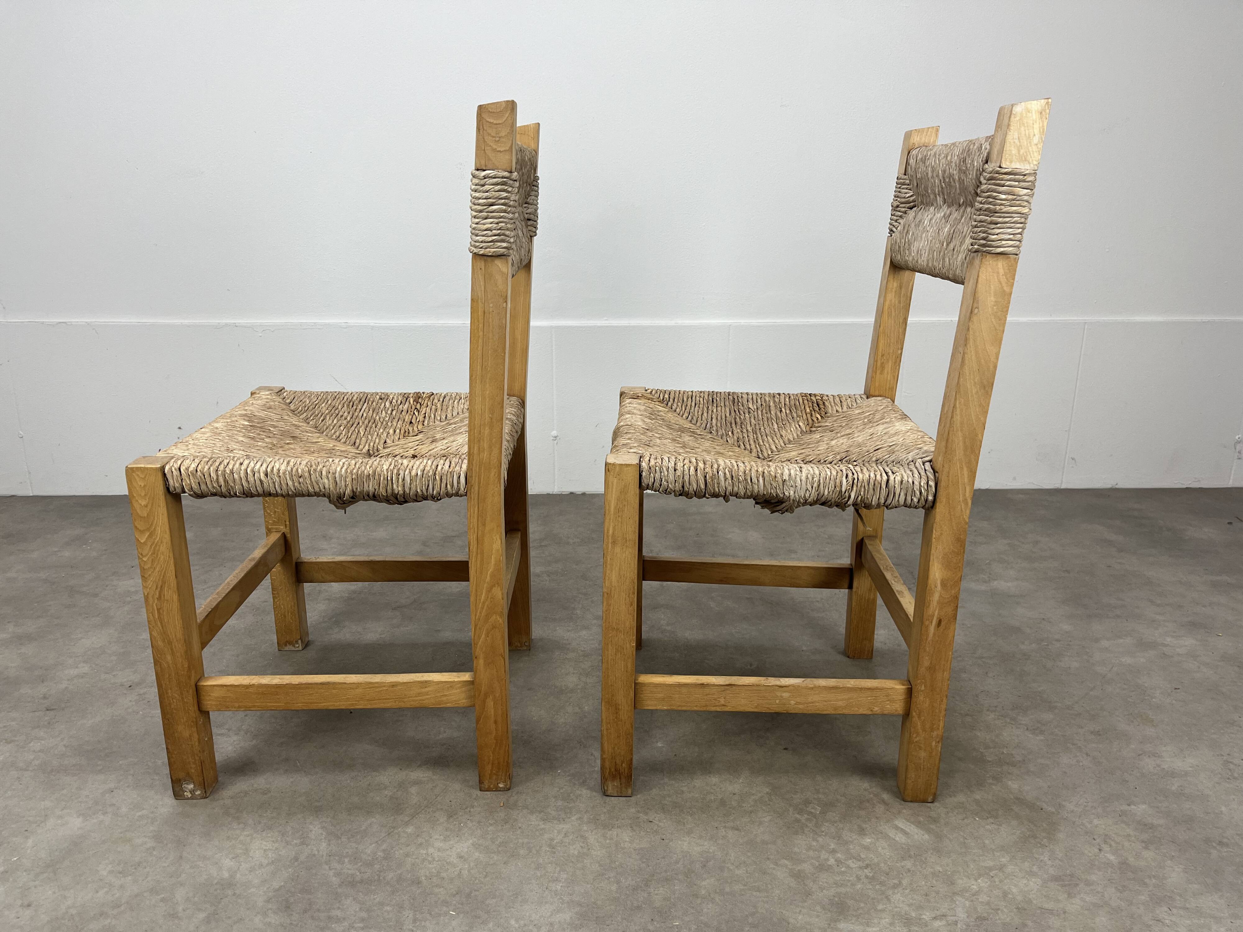2 straw and wood chairs in brutalist style