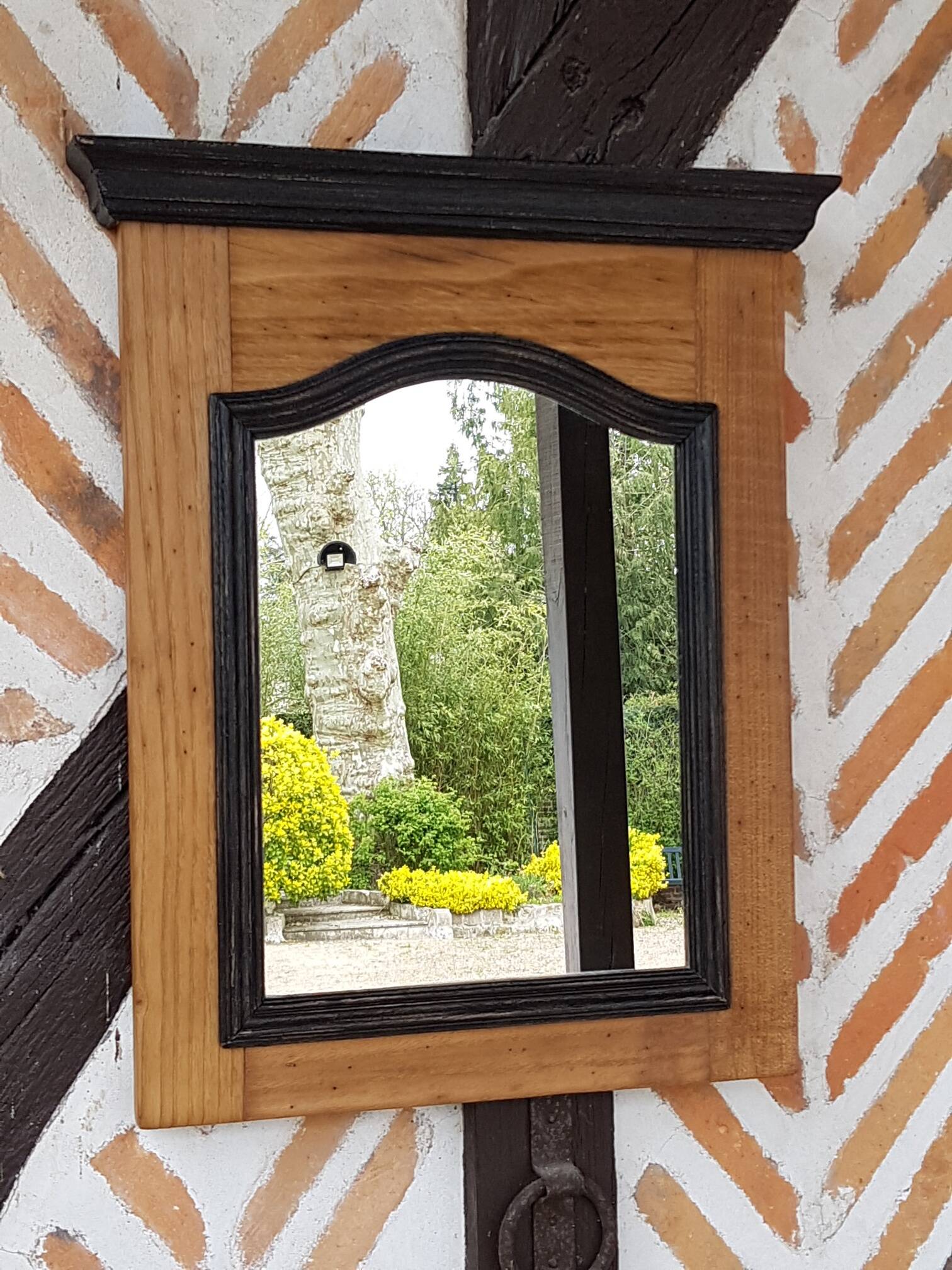 Black mirror and raw natural wood