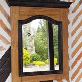 Black mirror and raw natural wood