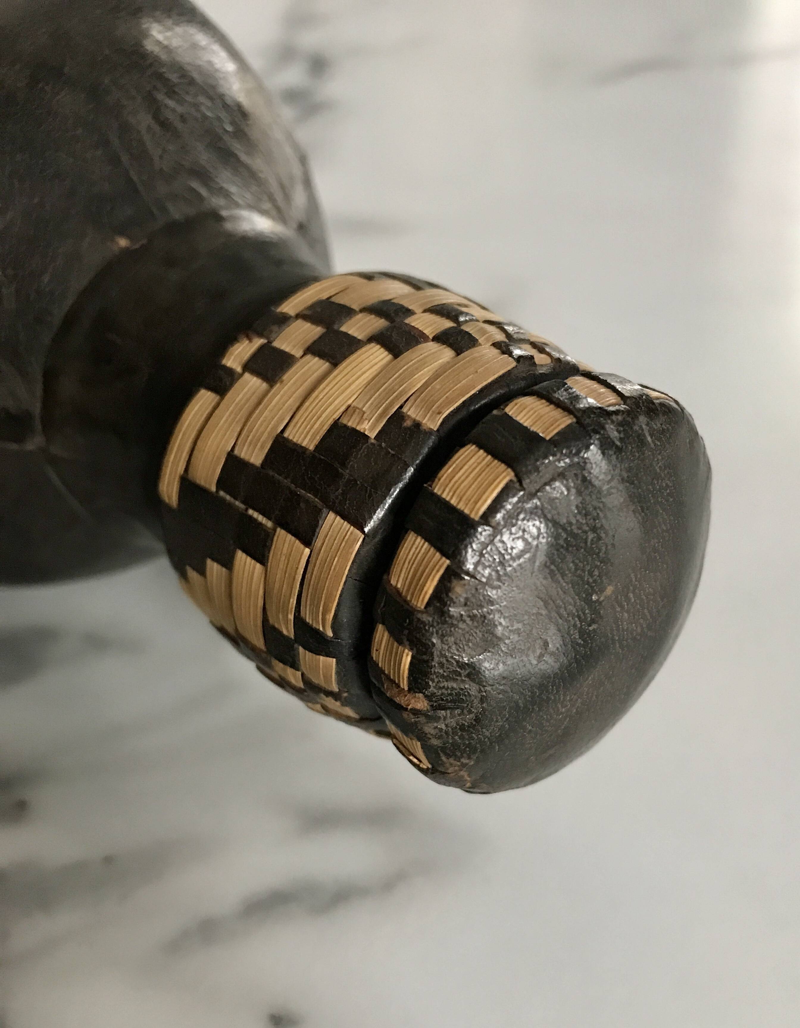 Ethnic decorative bottle in leather and raffia braiding