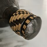Ethnic decorative bottle in leather and raffia braiding
