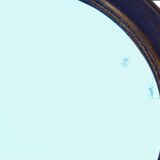 Round mirror in solid oak, bevelled, damaged, diameter 56cm.