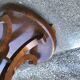 Art Deco side table in brown walnut, round top and scroll legs, France 1930s.