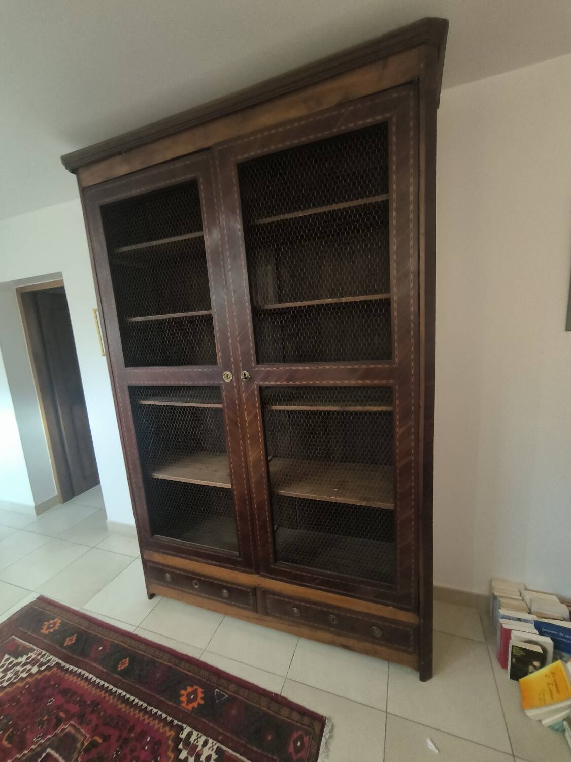 Library in marquetry with a grille from the Louis XVI period.