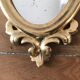 Paire de miroirs rococo dorés en bois sculpté