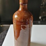 Old bottle in varnished ground.