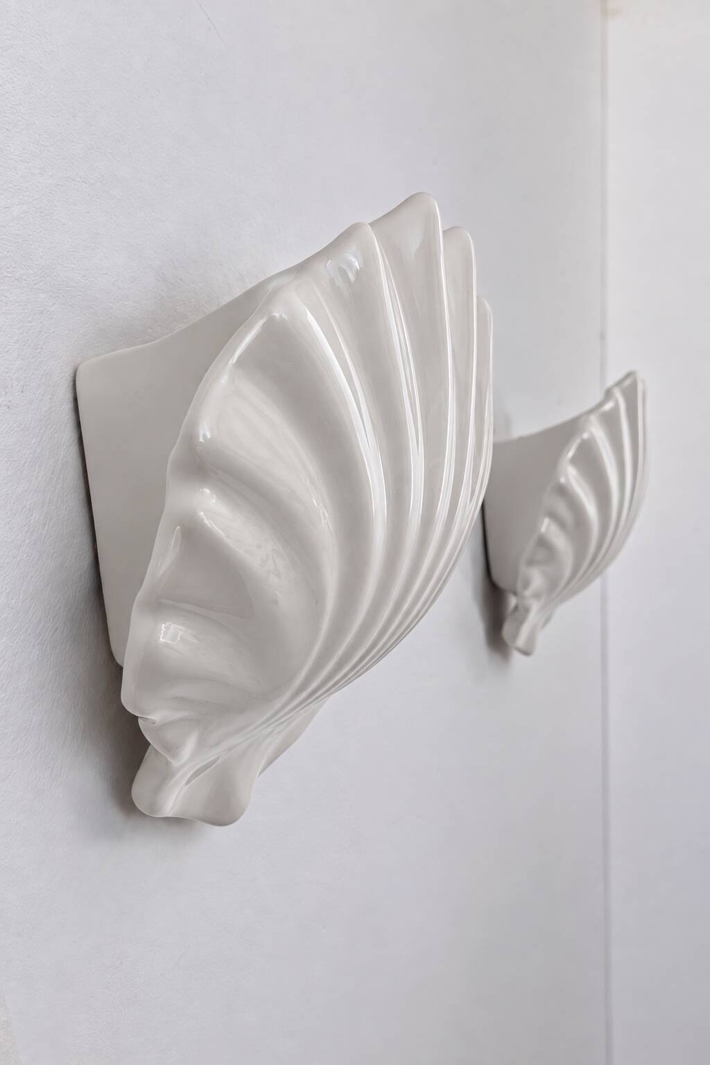 Vintage pair of white porcelain wall lights, France 1970.
