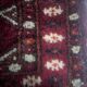 Antique wool rugs with designs on a red background, 20th century.