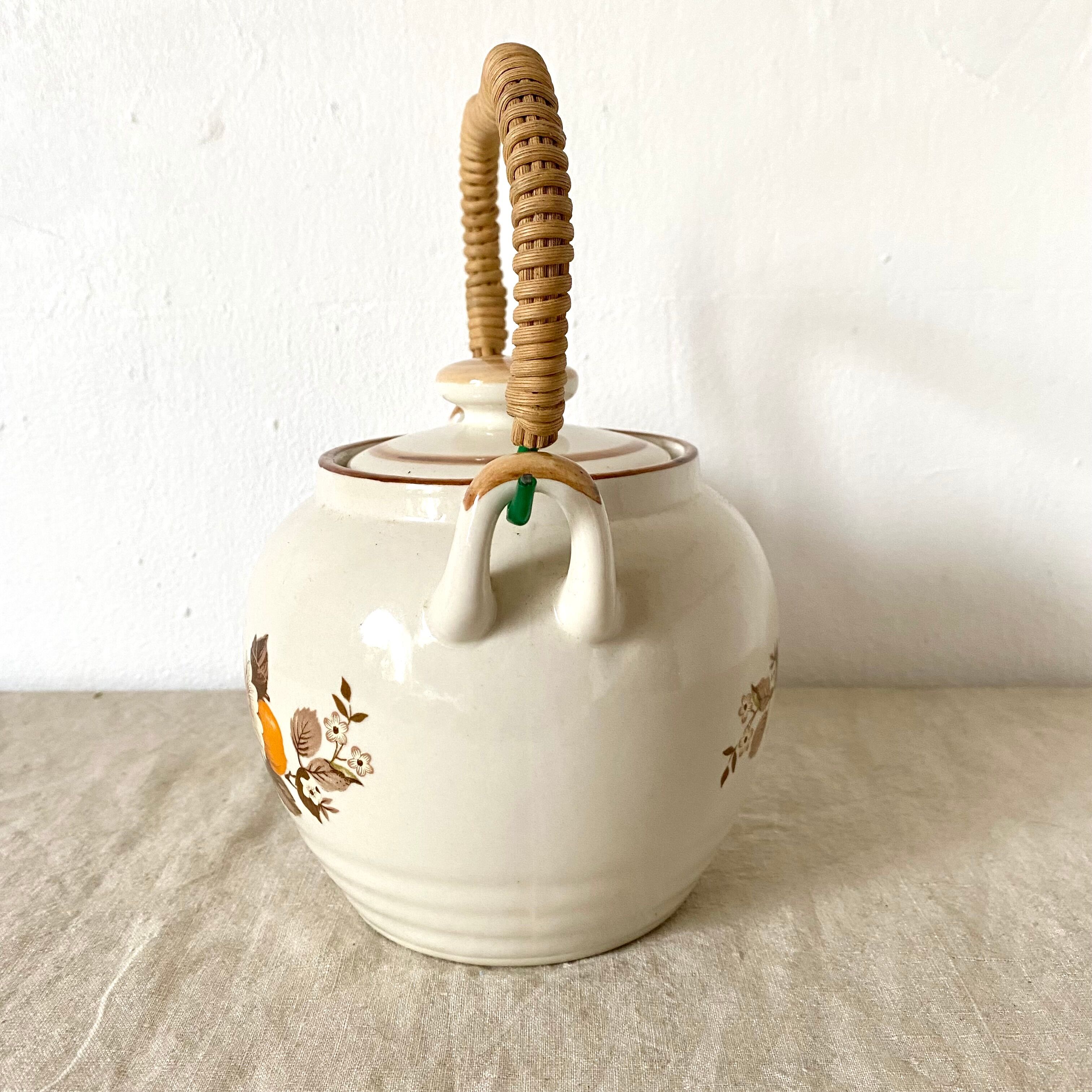 Vintage porcelain and rattan teapot