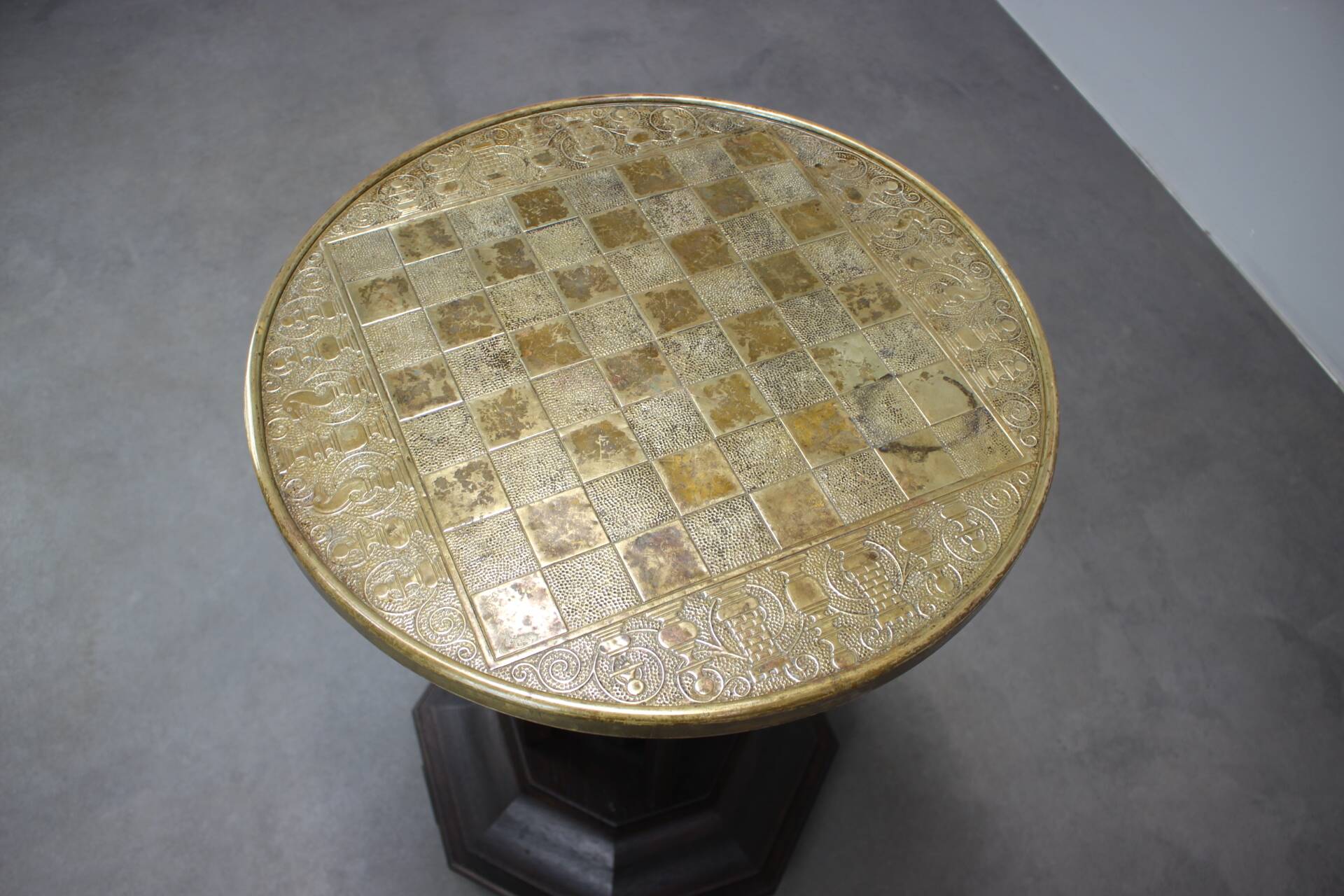 Art Deco chess table from the 1930s with a hand-decorated brass top and a stained oak base.