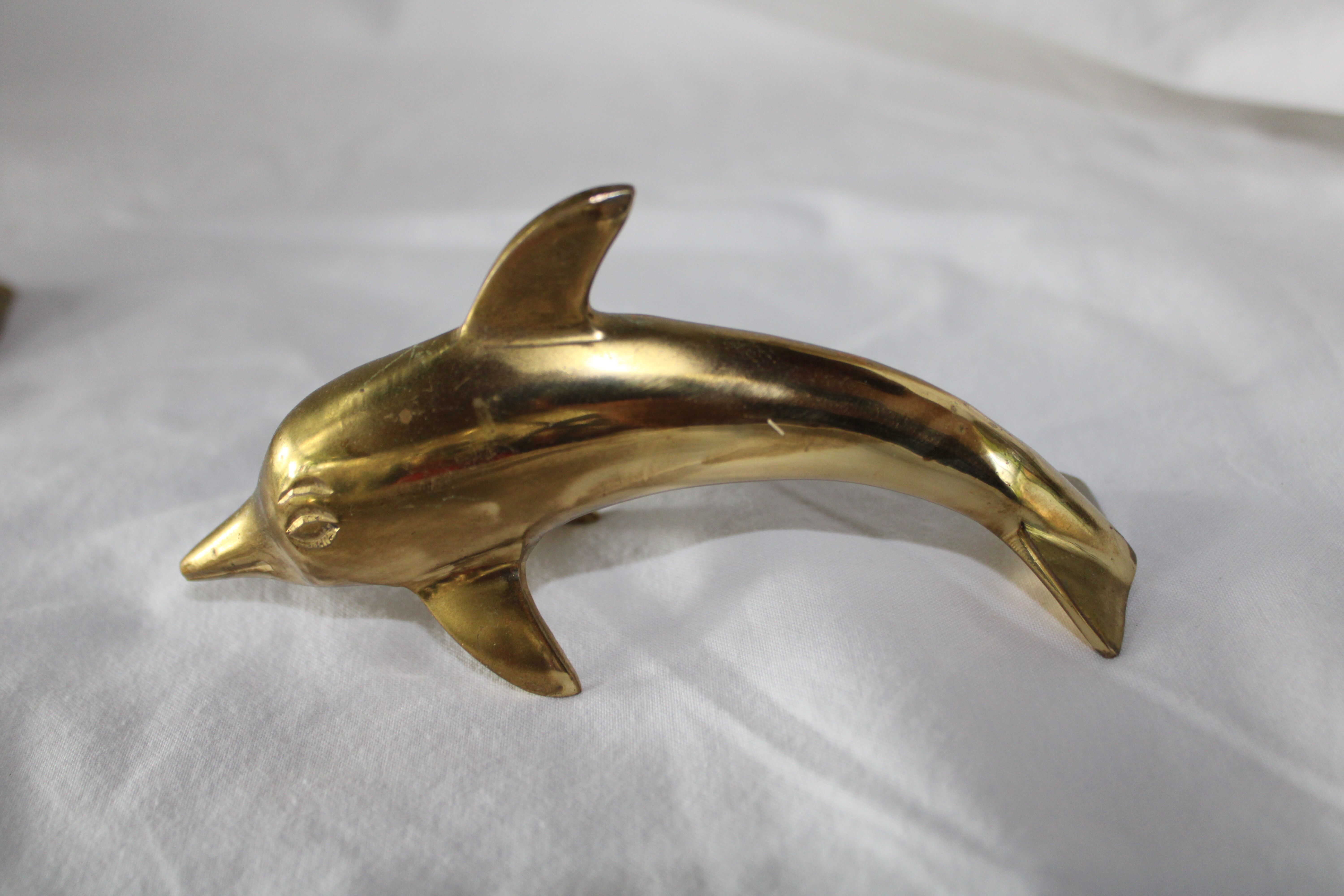Family of dolphins in vintage brass
